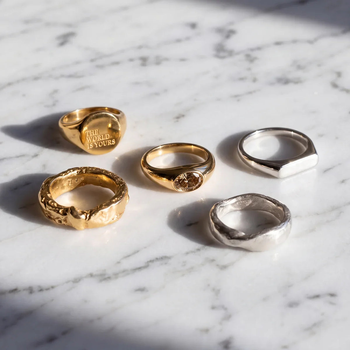 signet rings men flat lay on marble
